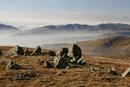 06-2238 Natural Stone Circle on Red Screes with the view west over mist filled valleys, Lake District, Cumbria